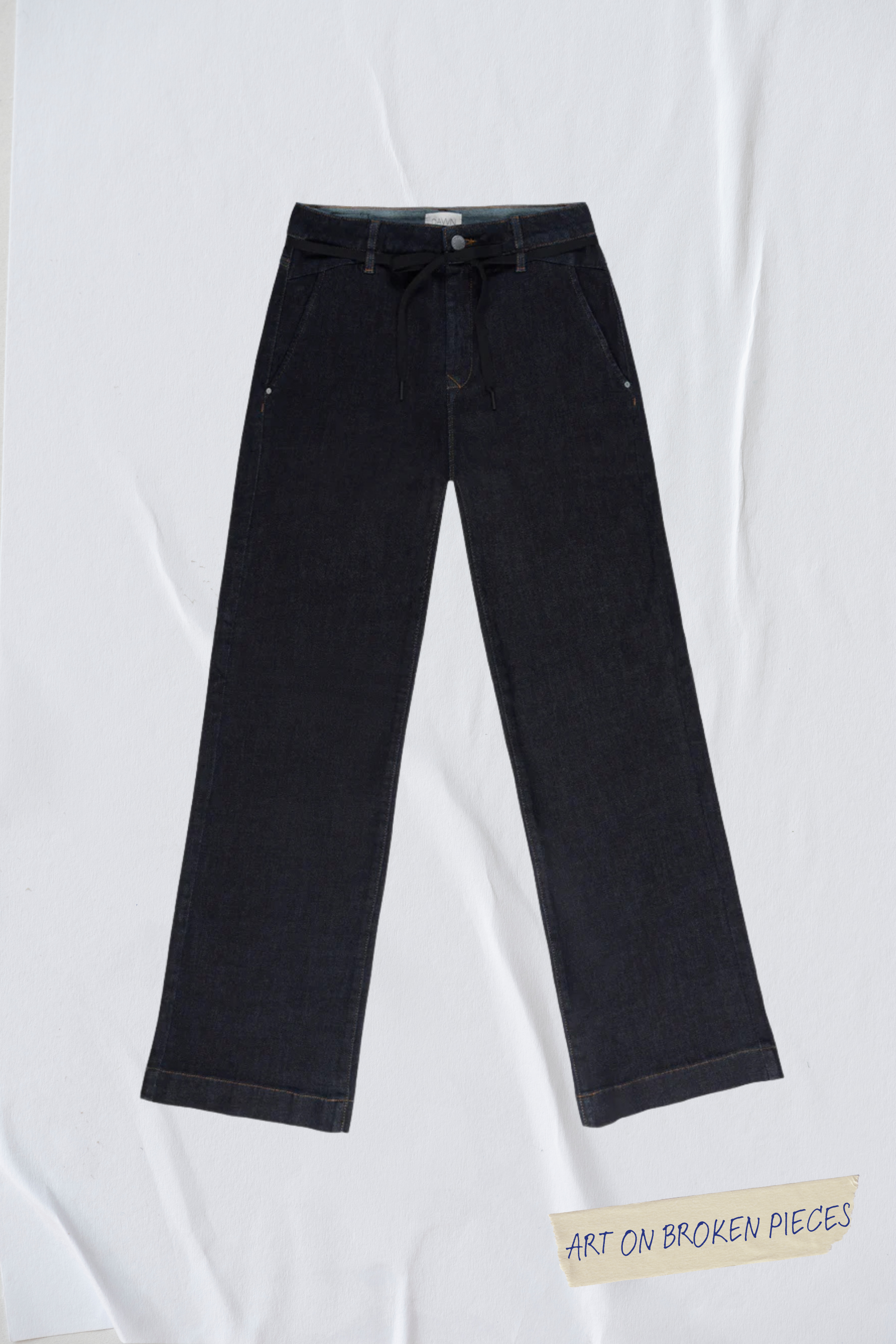 Raw Blue DEW Cropped Flared Jeans mit französischen Taschen, hoher Taille und ausgestelltem Bein; schwarzer Kordelgürtel; Art on Broken Pieces-Label sichtbar.